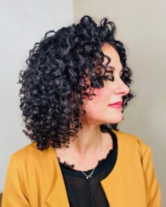 Donna con capelli ricci medi neri